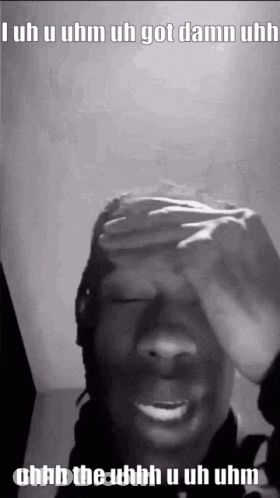A Black And White Photo Of A Person Covering Their Face With Their Hand . GIF