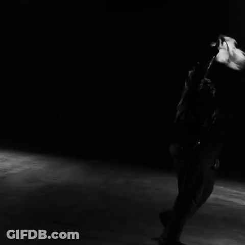 A Black And White Photo Of A Person Dancing In Front Of A Row Of Speakers GIF