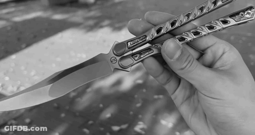 A Black And White Photo Of A Person Holding A Knife With The Word Xtreme On It GIF