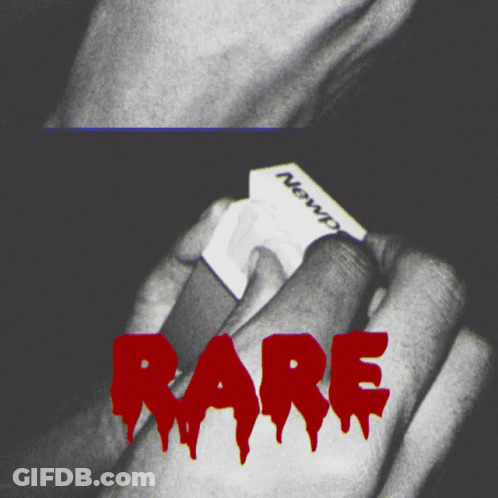 A Black And White Photo Of A Person Holding A Piece Of Paper With The Word Rare In Red GIF