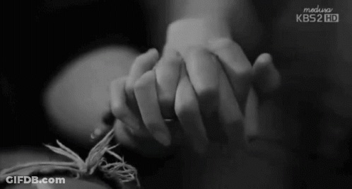 A Black And White Photo Of A Person Holding Another Person 'S Hand With Kbs2 Hd Written On The Bottom GIF