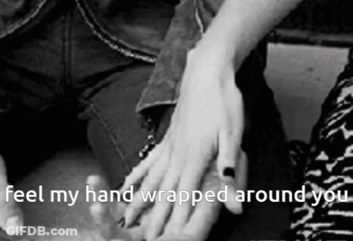 A Black And White Photo Of A Person Holding Another Person 'S Hand With The Caption " Feel My Hand Wrapped Around You " GIF