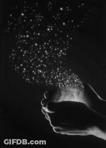 A Black And White Photo Of A Person Holding Stars In Their Hands . GIF