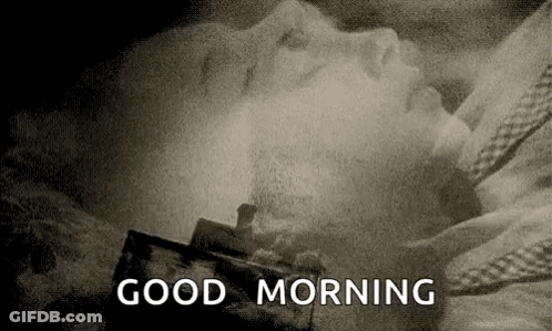 A Black And White Photo Of A Person Laying In A Bed With The Words `` Good Morning '' Written In The Corner . GIF