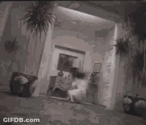 A Black And White Photo Of A Person Laying On A Couch With Their Legs Crossed . GIF