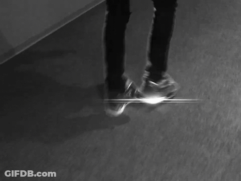 A Black And White Photo Of A Person Laying On The Floor With Their Head Down . GIF
