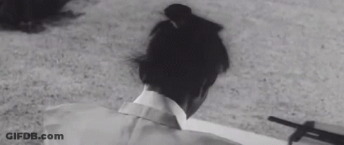 A Black And White Photo Of A Person Laying On The Ground With A Shadow On The Ground . GIF