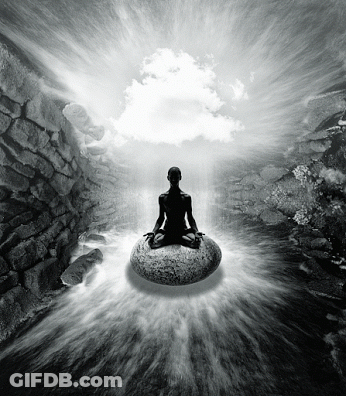 A Black And White Photo Of A Person Meditating On A Large Rock GIF