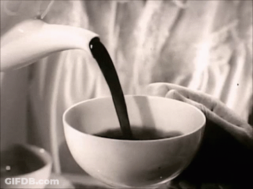 A Black And White Photo Of A Person Pouring A Cup Of Coffee GIF
