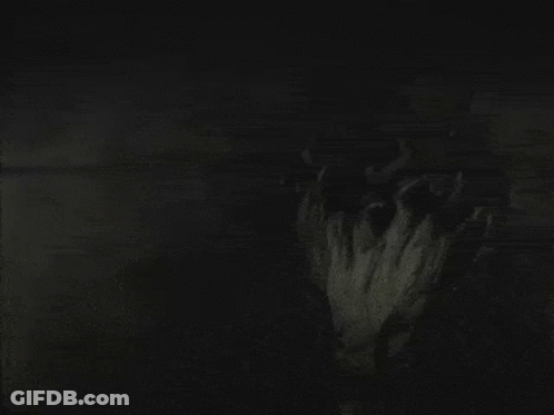 A Black And White Photo Of A Person 'S Face In The Dark GIF