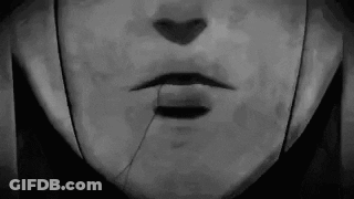 A Black And White Photo Of A Person 'S Face With A Broken Nose And Mouth . GIF