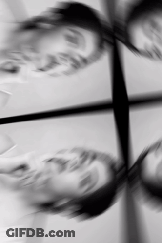 A Black And White Photo Of A Person 'S Face With A Reflection GIF