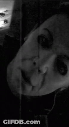 A Black And White Photo Of A Person 'S Face With Their Eyes Closed GIF