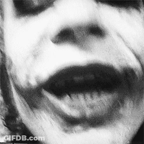 A Black And White Photo Of A Person 'S Face With Their Mouth Open And Their Tongue Sticking Out . GIF
