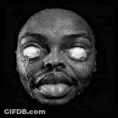 A Black And White Photo Of A Person 'S Face With Water Drops On It GIF