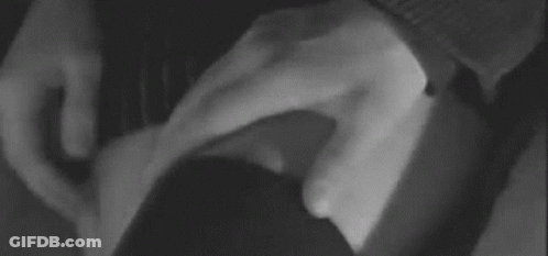 A Black And White Photo Of A Person 'S Hand On A Woman 'S Leg . GIF