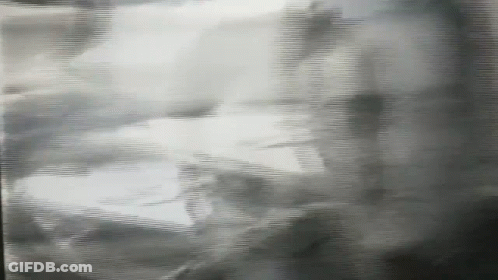 A Black And White Photo Of A Person 'S Shadow On A Wall GIF