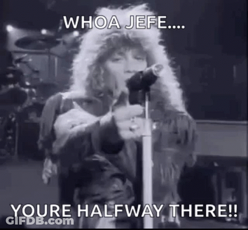 A Black And White Photo Of A Person Singing Into A Microphone On A Stage . GIF