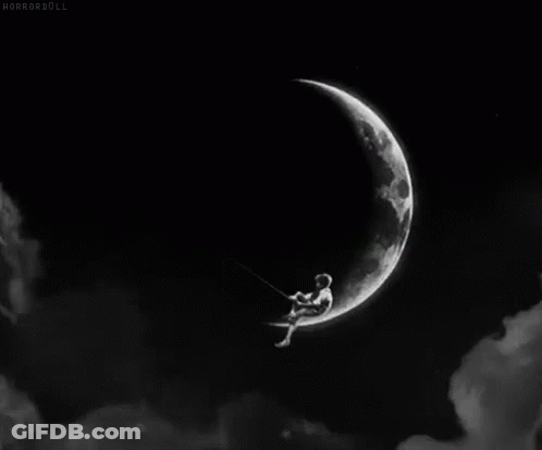 A Black And White Photo Of A Person Sitting On A Swing On A Crescent Moon . GIF