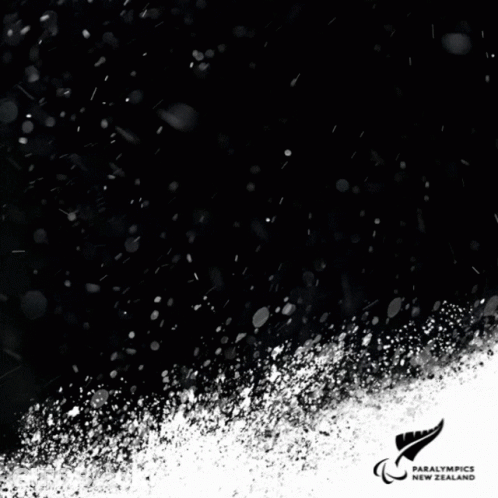 A Black And White Photo Of A Person Skiing With The Number 35 On His Shirt GIF