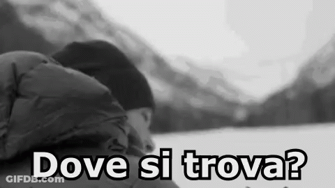A Black And White Photo Of A Person Sleeping In The Snow With The Words `` Dove Si Trova '' Written On The Bottom . GIF
