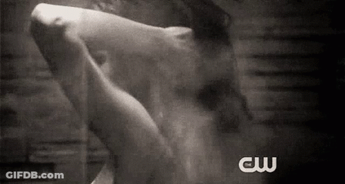 A Black And White Photo Of A Person Taking A Shower With The Words Cw Written On The Bottom . GIF