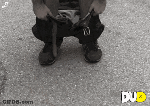 Black And White Photo Of Person Taking Off Pants Dux Text GIF