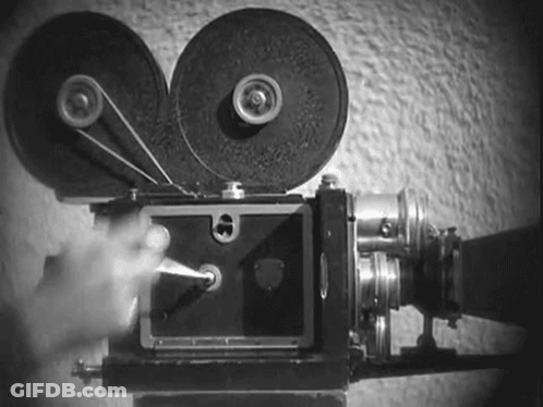 A Black And White Photo Of A Person Using A Film Camera . GIF
