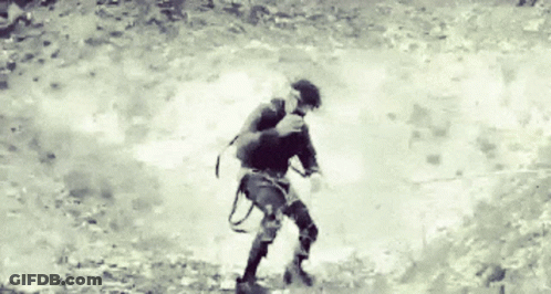 A Black And White Photo Of A Person Walking GIF