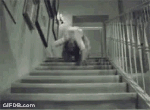 A Black And White Photo Of A Person Walking Up Stairs . GIF