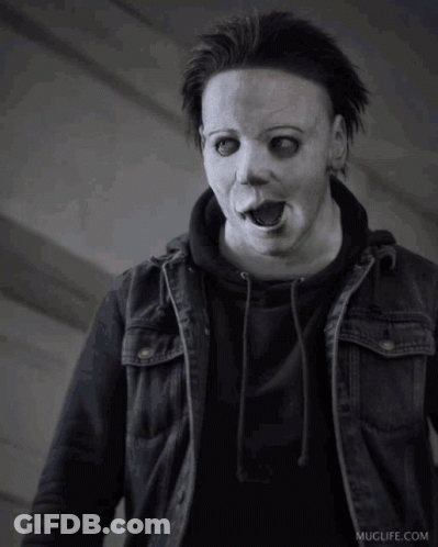 A Black And White Photo Of A Person Wearing A Mask And A Jacket GIF