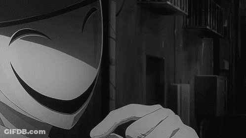 A Black And White Photo Of A Person Wearing A Mask With A Smiley Face . GIF