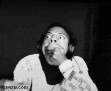 A Black And White Photo Of A Person Wearing Headphones Making A Funny Face . GIF