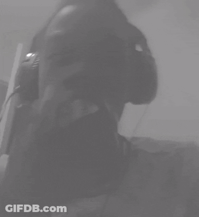 A Black And White Photo Of A Person Wearing Headphones With Their Eyes Closed GIF