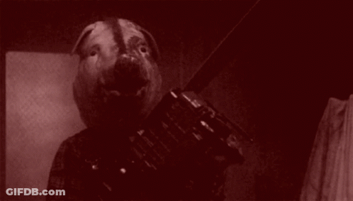A Black And White Photo Of A Person With A Pig Head . GIF