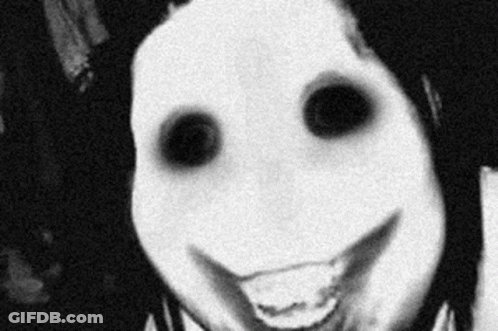 A Black And White Photo Of A Person With A Scary Face And Black Eyes Smiling . GIF