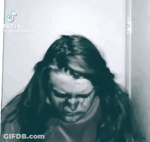 A Black And White Photo Of A Person With Long Hair And A Tiktok Logo GIF