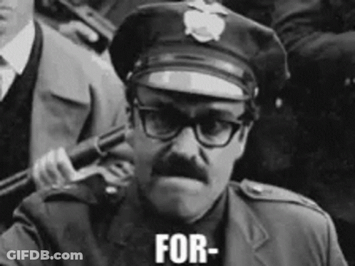 A Black And White Photo Of A Police Officer Holding A Gun And The Words For Written On His Face GIF