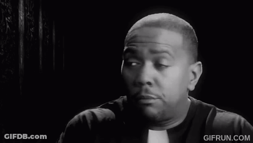 A Black And White Photo Of A Priest Making A Face GIF