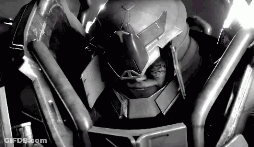 A Black And White Photo Of A Robot Wearing A Helmet And Armor . GIF