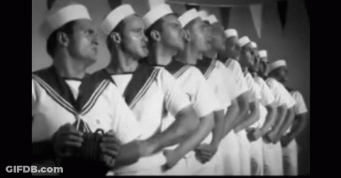 A Black And White Photo Of A Row Of Men In Sailor Uniforms GIF