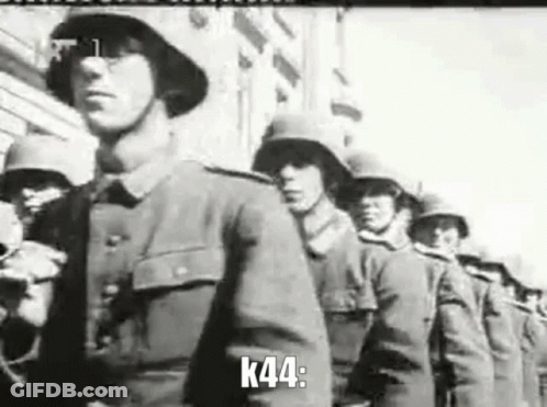 A Black And White Photo Of A Row Of Soldiers Marching In A Parade . GIF