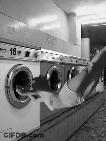 A Black And White Photo Of A Row Of Washing Machines With The Number 16 On Them GIF