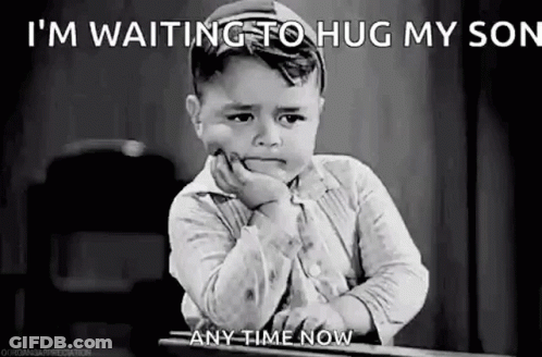 A Black And White Photo Of A Sad Little Boy Sitting At A Table . GIF