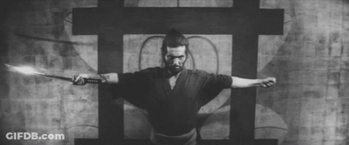 A Black And White Photo Of A Samurai Holding A Sword . GIF
