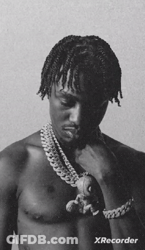 A Black And White Photo Of A Shirtless Man Holding A Teddy Bear With Xrecorder Written On The Bottom GIF