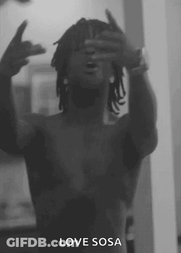 A Black And White Photo Of A Shirtless Man Making A Peace Sign GIF