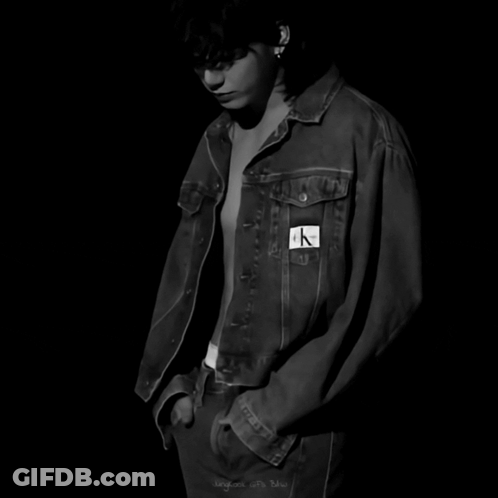 A Black And White Photo Of A Shirtless Man Wearing A Calvin Klein Denim Jacket GIF