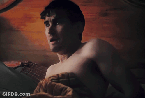 A Black And White Photo Of A Shirtless Man With Cartoon Eyes On His Face GIF