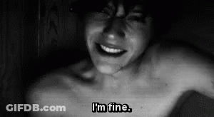 A Black And White Photo Of A Shirtless Man With The Words `` I 'M Fine '' Written On His Chest . GIF